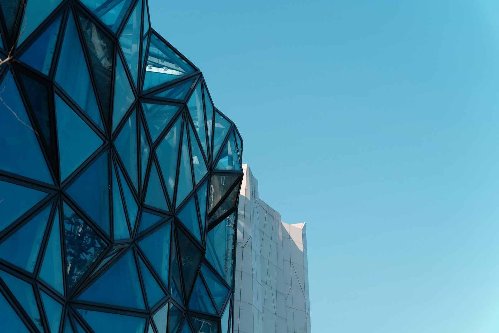 Blue glass building facade, used as editorial imagery rather than a company office photograph